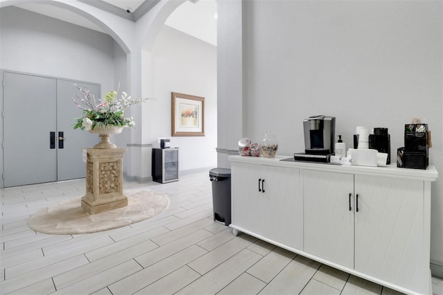 1330 Mariposa Cir Unit 104, Naples, FL 34105 - bar area featuring arched walkways and wood finish floors