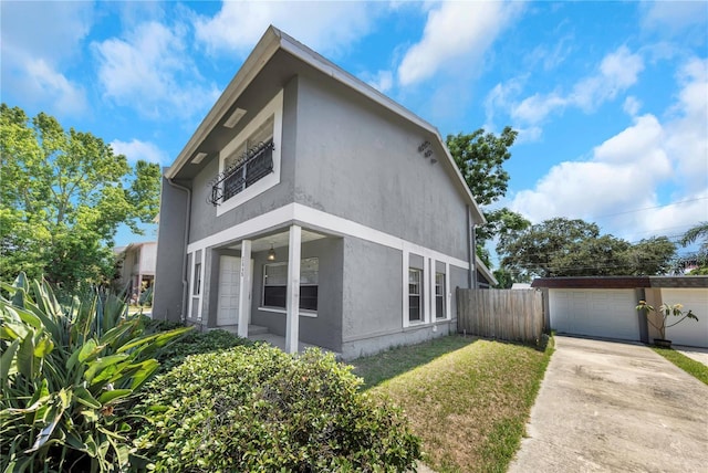 2048 Los Lomas Dr, Clearwater, FL 33763 - view of property exterior with stucco siding, concrete driveway, and a garage