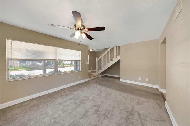 2048 Los Lomas Dr, Clearwater, FL 33763 - unfurnished living room with stairs, a ceiling fan, carpet floors, and baseboards