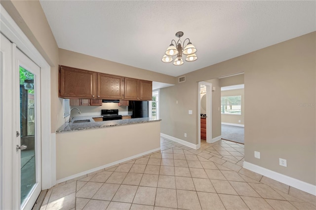 2048 Los Lomas Dr, Clearwater, FL 33763 - kitchen featuring black electric range oven, a sink, a chandelier, light tile patterned flooring, and baseboards