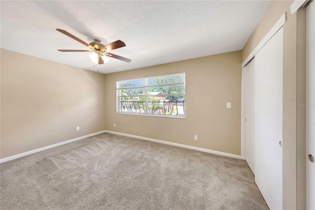 2048 Los Lomas Dr, Clearwater, FL 33763 - unfurnished bedroom with carpet flooring, a textured ceiling, baseboards, and a closet