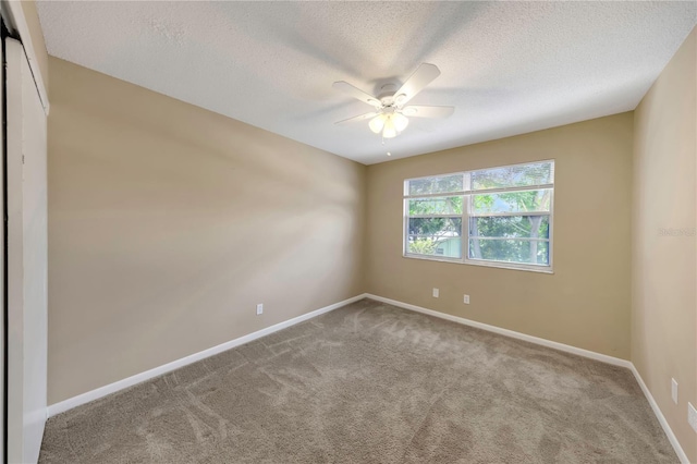 2048 Los Lomas Dr, Clearwater, FL 33763 - unfurnished room with ceiling fan, carpet floors, baseboards, and a textured ceiling