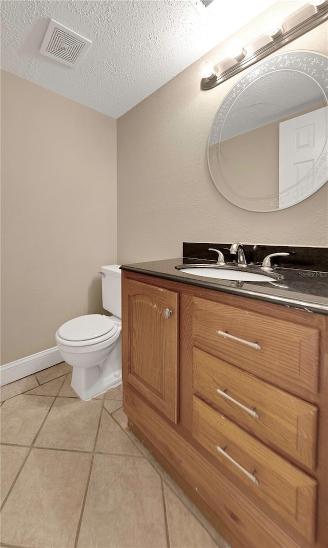 2048 Los Lomas Dr, Clearwater, FL 33763 - bathroom featuring vanity, toilet, tile patterned flooring, and a textured ceiling