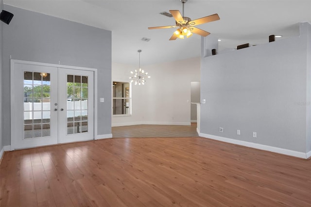 unfurnished living room featuring french doors, high vaulted ceiling, wood-type flooring, baseboards, and a chandelier