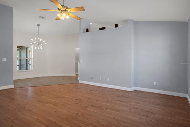 empty room with wood finished floors, high vaulted ceiling, a chandelier, ceiling fan, and baseboards