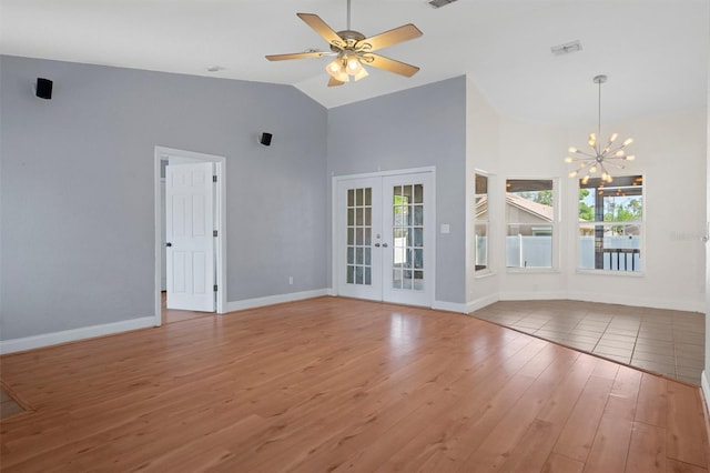 unfurnished living room with french doors, wood finished floors, high vaulted ceiling, a chandelier, and baseboards