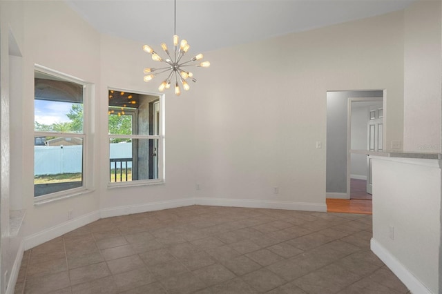 unfurnished dining area featuring a chandelier, tile patterned flooring, and baseboards