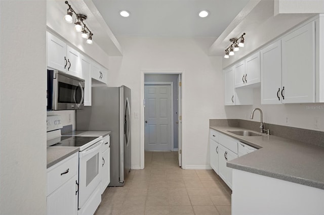 kitchen featuring white electric stove, stainless steel microwave, a sink, white cabinetry, and recessed lighting