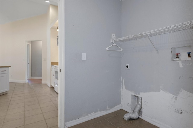laundry room featuring electric dryer hookup, light tile patterned floors, washer hookup, and baseboards