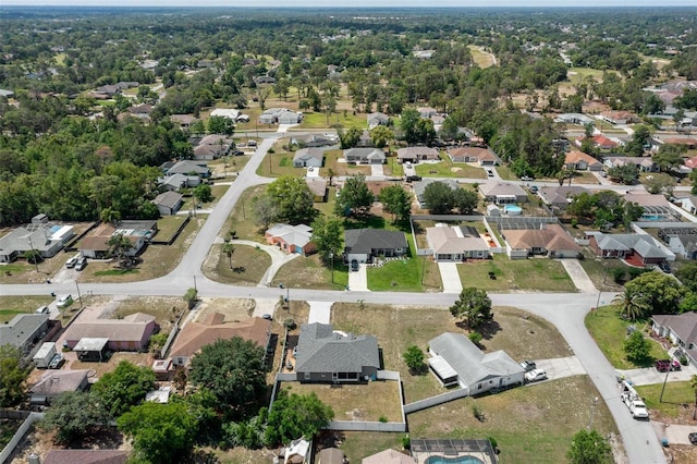 aerial view of property and surrounding area featuring nearby suburban area