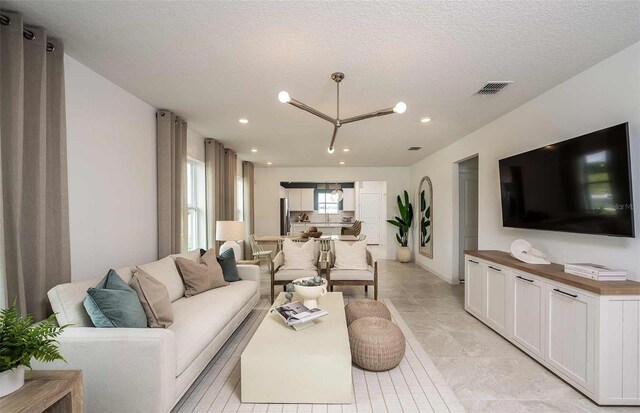 6780 SW 90th Loop, Ocala, FL 34476 - living area featuring recessed lighting, a textured ceiling, and light tile patterned floors