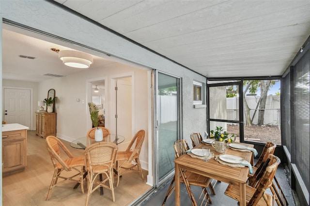 sunroom with outdoor dining area