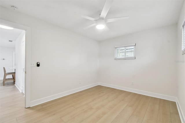 unfurnished room with ceiling fan, baseboards, and light wood-type flooring