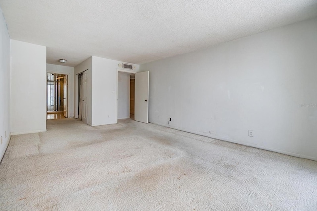 spare room featuring light colored carpet