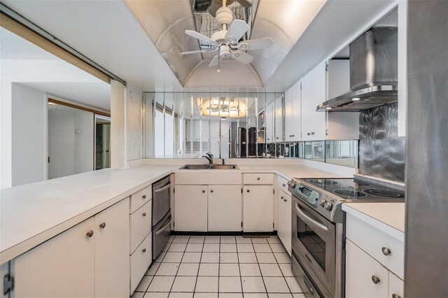 1400 Gulf Blvd Unit 306, Clearwater Beach, FL 33767 - kitchen with appliances with stainless steel finishes, wall chimney range hood, light countertops, light tile patterned floors, and ceiling fan
