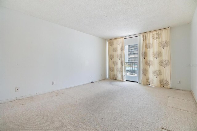 1400 Gulf Blvd Unit 306, Clearwater Beach, FL 33767 - carpeted spare room with floor to ceiling windows and a textured ceiling