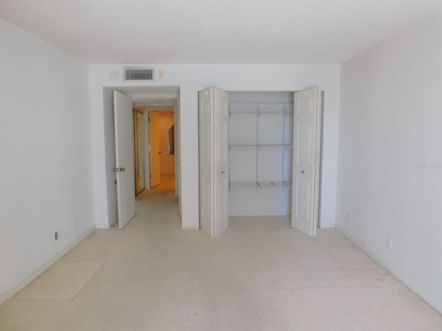 1400 Gulf Blvd Unit 306, Clearwater Beach, FL 33767 - unfurnished bedroom featuring light carpet and a closet