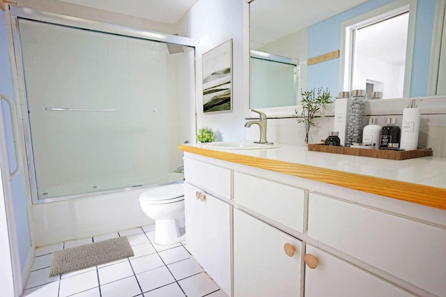 1111 Briarwood Rd, Brandon, FL 33511 - full bath with tile patterned flooring, toilet, combined bath / shower with glass door, vanity, and backsplash