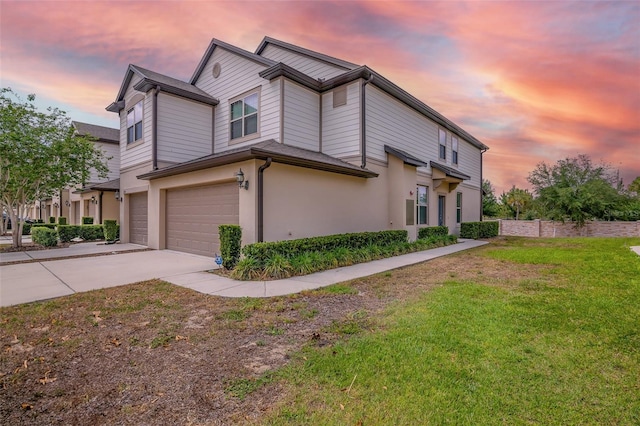 1101 Pavia Dr, Apopka, FL 32703 - view of home's exterior featuring driveway, a garage, stucco siding, and a lawn