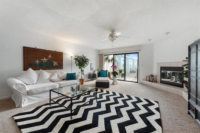 745 Pinellas Bayway S Unit 206, Saint Petersburg, FL 33715 - living area featuring carpet floors, a textured ceiling, a ceiling fan, and a tiled fireplace