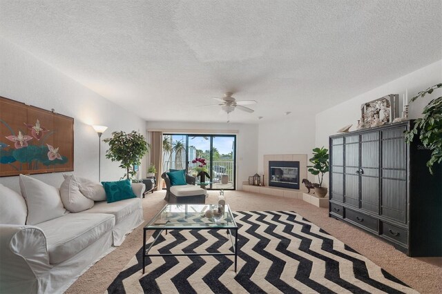 745 Pinellas Bayway S Unit 206, Saint Petersburg, FL 33715 - living area with carpet floors, a textured ceiling, ceiling fan, and a fireplace