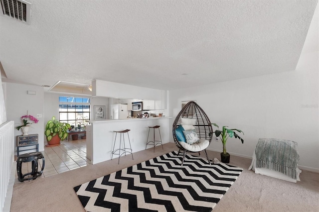 745 Pinellas Bayway S Unit 206, Saint Petersburg, FL 33715 - sitting room featuring attic access, carpet flooring, and a textured ceiling