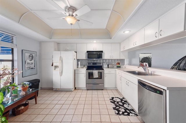 745 Pinellas Bayway S Unit 206, Saint Petersburg, FL 33715 - kitchen featuring appliances with stainless steel finishes, a sink, a raised ceiling, and light countertops
