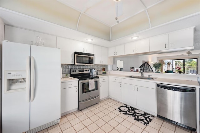 745 Pinellas Bayway S Unit 206, Saint Petersburg, FL 33715 - kitchen featuring appliances with stainless steel finishes, a sink, light countertops, white cabinetry, and recessed lighting