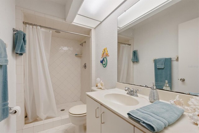 745 Pinellas Bayway S Unit 206, Saint Petersburg, FL 33715 - full bath with a stall shower, toilet, vanity, and tile patterned floors