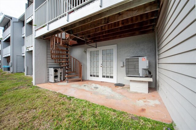745 Pinellas Bayway S Unit 206, Saint Petersburg, FL 33715 - view of patio / terrace with stairway, central AC unit, and french doors