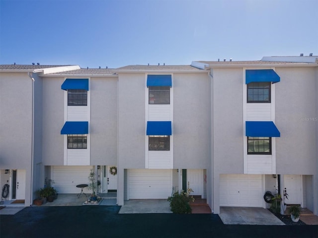 745 Pinellas Bayway S Unit 206, Saint Petersburg, FL 33715 - multi unit property featuring stucco siding, a garage, and driveway