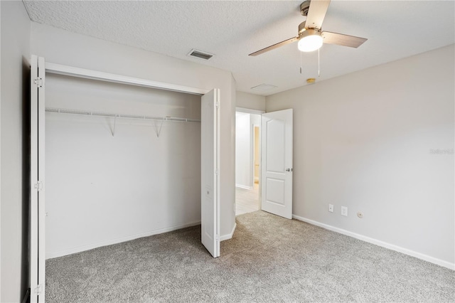 unfurnished bedroom featuring a closet, visible vents, carpet flooring, a ceiling fan, and baseboards