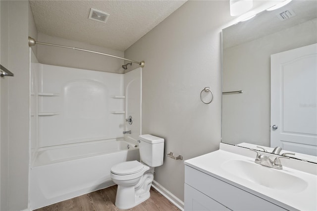 full bathroom featuring toilet, a textured ceiling, visible vents, and wood finished floors
