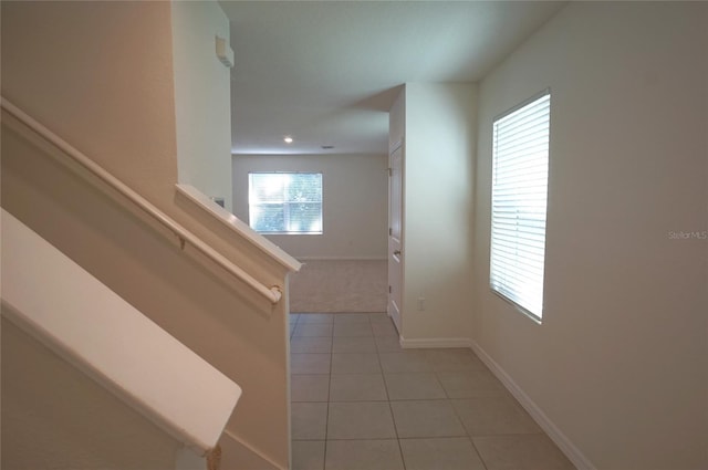 10928 Carlton Fields Dr, Riverview, FL 33579 - hall featuring light tile patterned floors, baseboards, recessed lighting, and light colored carpet
