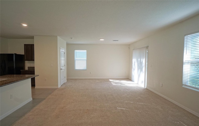 10928 Carlton Fields Dr, Riverview, FL 33579 - unfurnished living room featuring light tile patterned floors, light carpet, baseboards, and recessed lighting