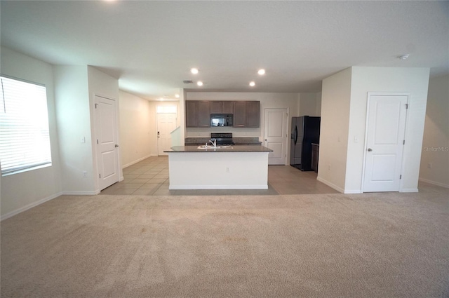 10928 Carlton Fields Dr, Riverview, FL 33579 - kitchen featuring light colored carpet, black appliances, recessed lighting, open floor plan, and dark countertops
