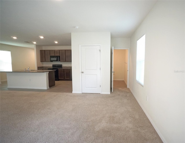 10928 Carlton Fields Dr, Riverview, FL 33579 - unfurnished living room featuring a sink, light colored carpet, baseboards, and recessed lighting