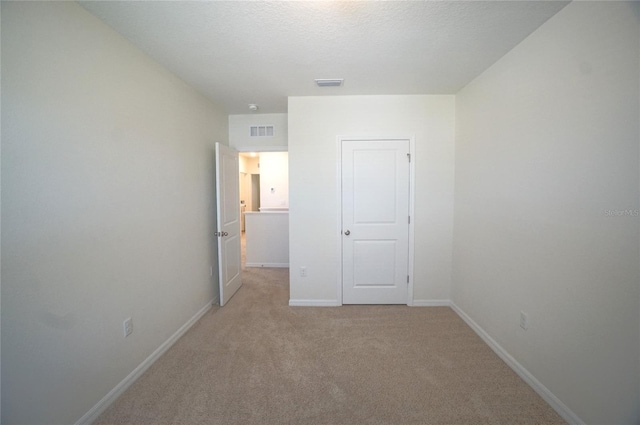 10928 Carlton Fields Dr, Riverview, FL 33579 - unfurnished bedroom with visible vents, baseboards, and light carpet