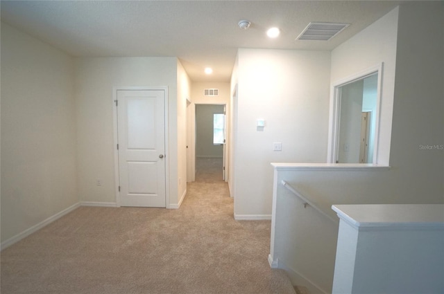 10928 Carlton Fields Dr, Riverview, FL 33579 - hall with light colored carpet, visible vents, an upstairs landing, and baseboards
