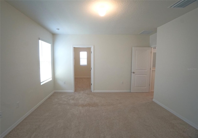 10928 Carlton Fields Dr, Riverview, FL 33579 - empty room with light colored carpet, visible vents, and baseboards
