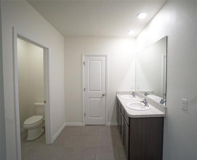 10928 Carlton Fields Dr, Riverview, FL 33579 - full bath with a sink, double vanity, toilet, and tile patterned floors