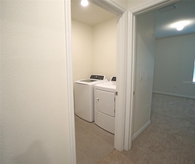 10928 Carlton Fields Dr, Riverview, FL 33579 - washroom featuring baseboards, visible vents, light colored carpet, and washer and clothes dryer