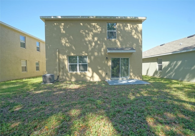 10928 Carlton Fields Dr, Riverview, FL 33579 - rear view of house featuring a yard, stucco siding, a patio, and central AC