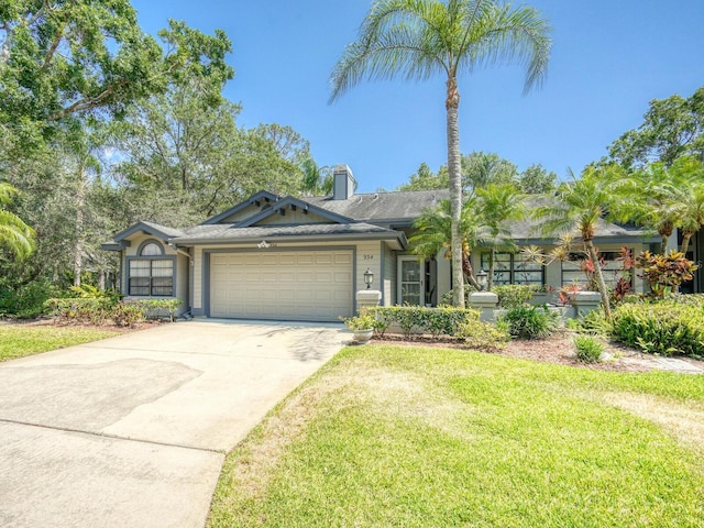 ranch-style house featuring a garage, driveway, a chimney, and a front lawn