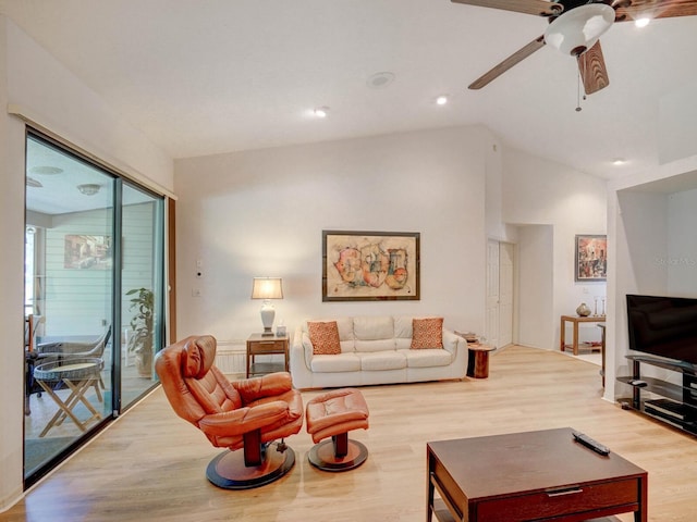 living area with wood finished floors, lofted ceiling, a ceiling fan, and recessed lighting