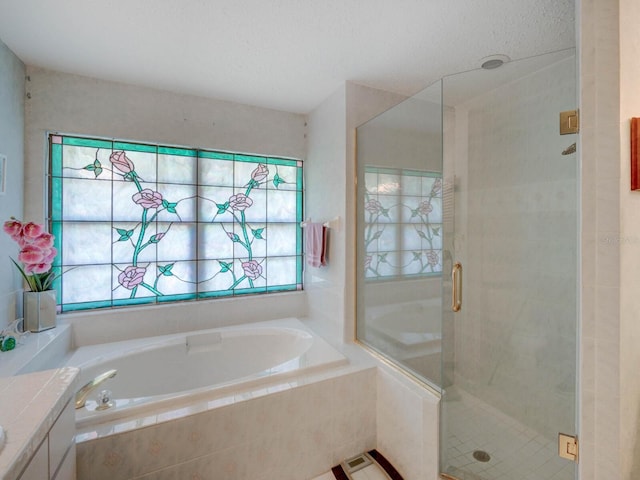 bathroom with a shower stall, a garden tub, and tile patterned flooring
