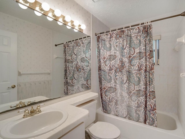full bathroom featuring shower / bath combo, a textured ceiling, vanity, and toilet