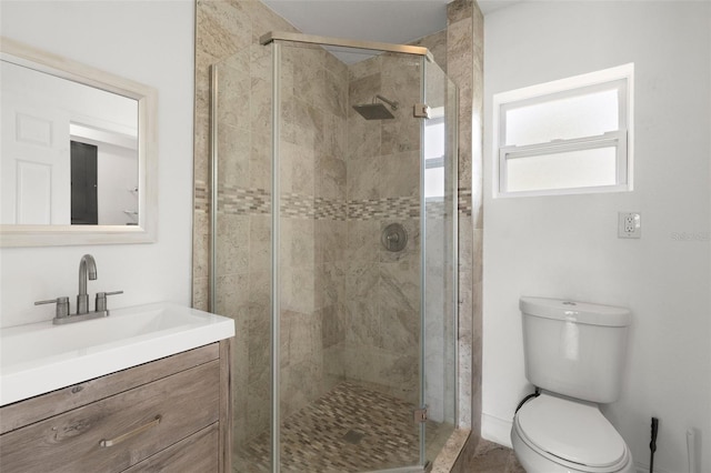 full bathroom with a stall shower, toilet, and vanity
