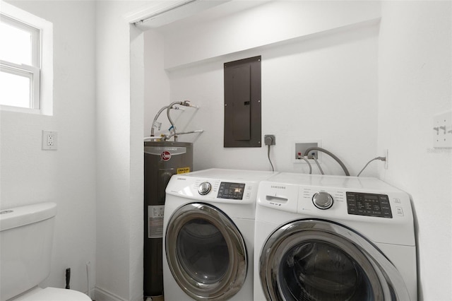 laundry area featuring electric panel, washing machine and dryer, and water heater