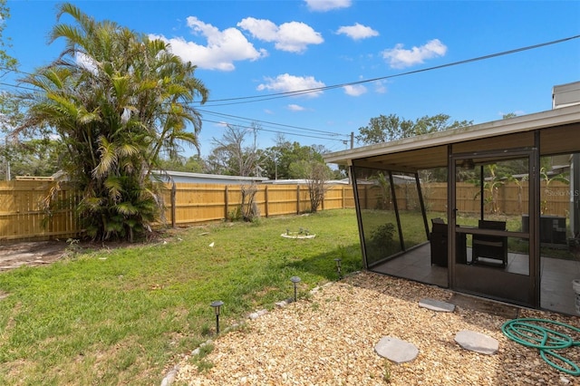 view of yard featuring central AC unit, a sunroom, and a patio area